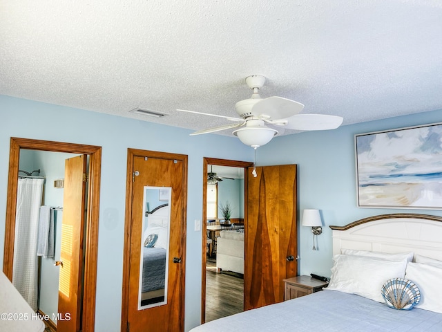 4704 S Va Dare Trl, Nags Head, NC 27959 - bedroom featuring a textured ceiling, wood finished floors, and a ceiling fan