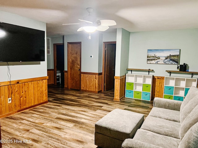 4704 S Va Dare Trl, Nags Head, NC 27959 - living area with wainscoting, wood finished floors, ceiling fan, and wood walls