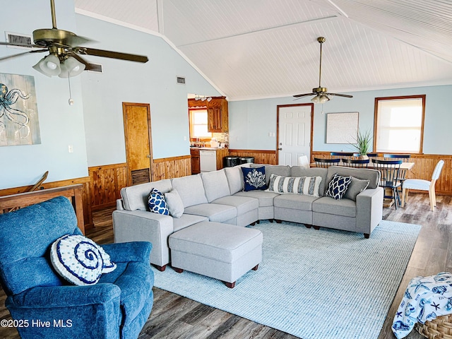 4704 S Va Dare Trl, Nags Head, NC 27959 - living area featuring a ceiling fan, wainscoting, wood finished floors, wood walls, and plenty of natural light