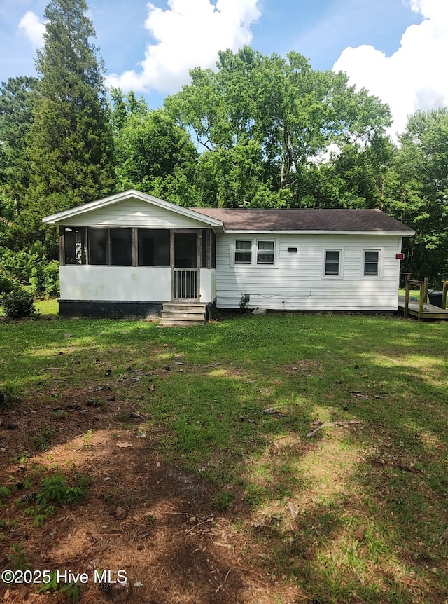 7757 Terra Ceia Rd, Pantego, NC 27860 - view of front of home with a sunroom, a front yard, and view of wooded area