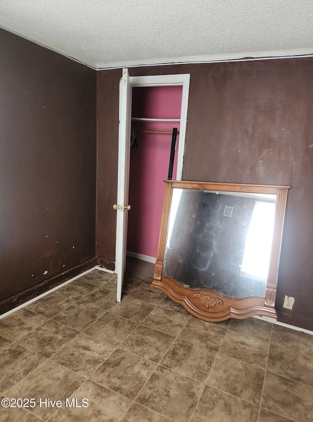 7757 Terra Ceia Rd, Pantego, NC 27860 - unfurnished bedroom featuring a textured ceiling, baseboards, and a closet