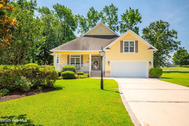 1209 Moultrie Dr NW, Calabash, NC 28467 - view of front of home with a porch, a front yard, a garage, concrete driveway, and roof with shingles