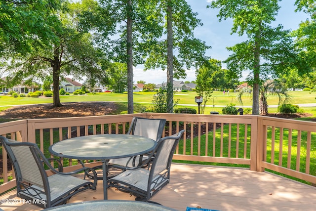 1209 Moultrie Dr NW, Calabash, NC 28467 - deck featuring outdoor dining space, view of golf course, a lawn, and a residential view