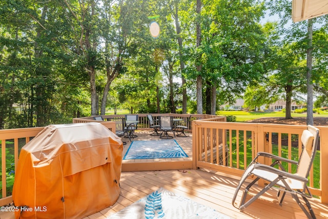 1209 Moultrie Dr NW, Calabash, NC 28467 - deck with outdoor dining space, view of scattered trees, and grilling area