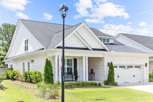 8116 Barstow Ln, Wilmington, NC 28411 - view of front of property featuring an attached garage, a front lawn, covered porch, and brick siding