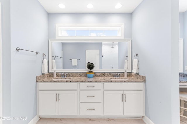 8116 Barstow Ln, Wilmington, NC 28411 - bathroom with double vanity, a shower, and plenty of natural light