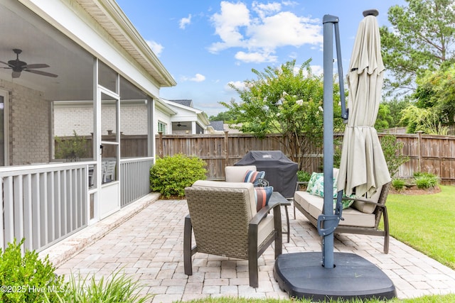 8116 Barstow Ln, Wilmington, NC 28411 - fenced backyard featuring a patio area, a ceiling fan, area for grilling, and a sunroom