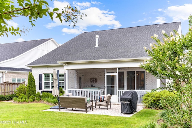 8116 Barstow Ln, Wilmington, NC 28411 - back of property with a patio area, brick siding, an outdoor hangout area, a sunroom, and a shingled roof