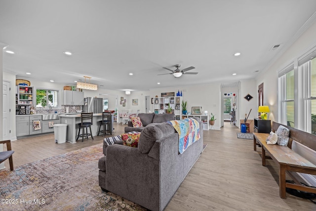 907 Sea Holly Ct, New Bern, NC 28560 - living room featuring recessed lighting, light wood-style flooring, ceiling fan, and crown molding