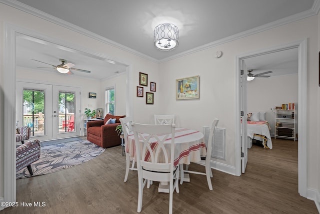 907 Sea Holly Ct, New Bern, NC 28560 - dining area featuring a ceiling fan, french doors, wood finished floors, and ornamental molding