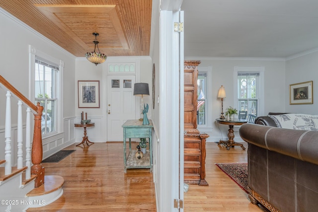 405 Hancock St, New Bern, NC 28560 - entrance foyer with light wood-type flooring, stairway, ornamental molding, wooden ceiling, and a wainscoted wall