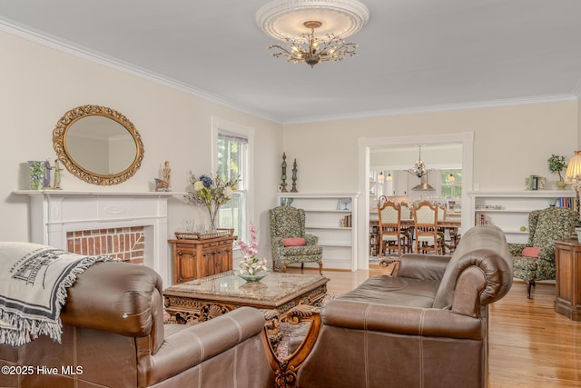 405 Hancock St, New Bern, NC 28560 - living room with a chandelier, crown molding, light wood-style floors, and a fireplace