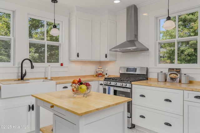 405 Hancock St, New Bern, NC 28560 - kitchen featuring wooden counters, wall chimney exhaust hood, stainless steel range with gas stovetop, a sink, and tasteful backsplash