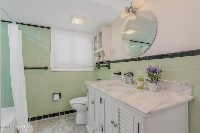 405 Hancock St, New Bern, NC 28560 - bathroom featuring tile walls, vanity, toilet, marble finish flooring, and shower / bath combination with curtain
