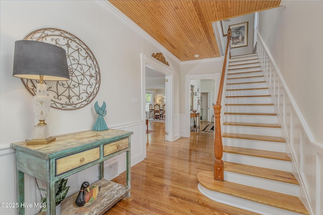 405 Hancock St, New Bern, NC 28560 - staircase with wooden ceiling, ornamental molding, wainscoting, wood finished floors, and a decorative wall