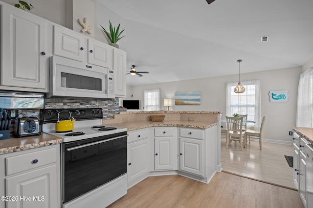 415 Greenville Ave Unit A, Carolina Beach, NC 28428 - kitchen featuring electric range, white microwave, a ceiling fan, decorative backsplash, and white cabinets