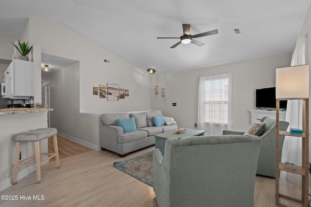 415 Greenville Ave Unit A, Carolina Beach, NC 28428 - living area featuring a ceiling fan, vaulted ceiling, and light wood finished floors