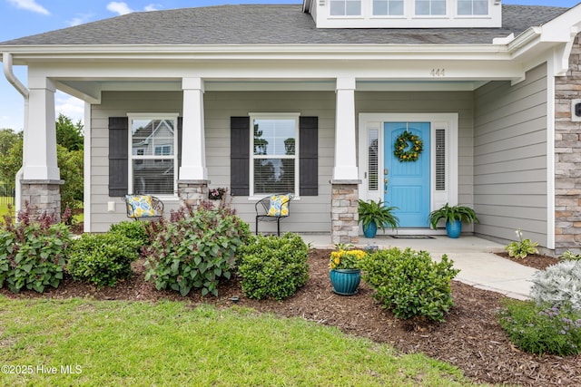 444 Island End Ct, Wilmington, NC 28412 - property entrance with covered porch, a shingled roof, and stone siding
