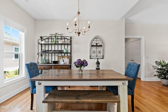 322 NE 42nd St, Oak Island, NC 28465 - dining space featuring a chandelier and light wood-style floors