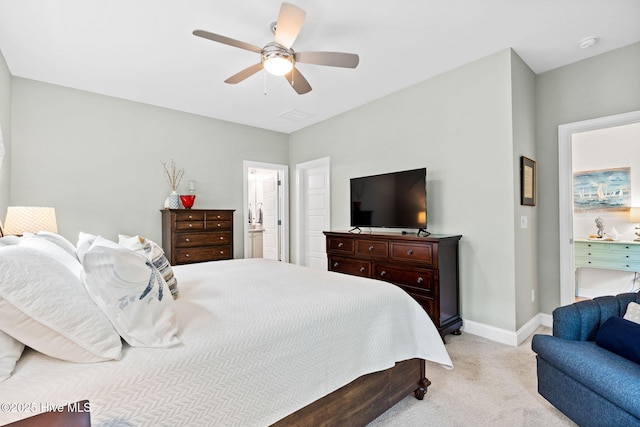 322 NE 42nd St, Oak Island, NC 28465 - bedroom featuring light colored carpet, ceiling fan, and ensuite bath