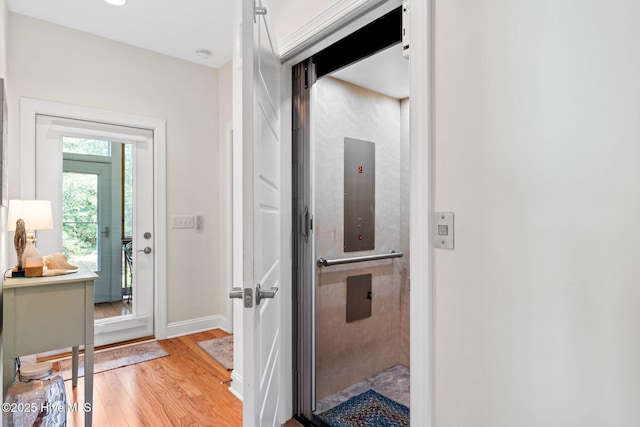 322 NE 42nd St, Oak Island, NC 28465 - hallway featuring light wood-style flooring and elevator