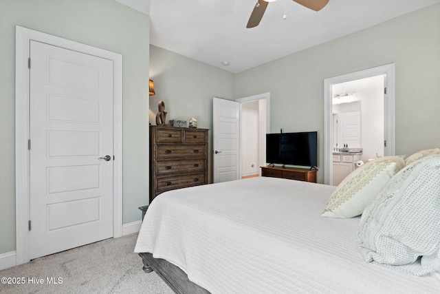 322 NE 42nd St, Oak Island, NC 28465 - bedroom with light carpet, a ceiling fan, and connected bathroom