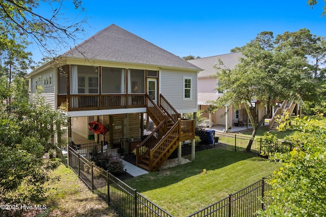 322 NE 42nd St, Oak Island, NC 28465 - back of property featuring stairway, a sunroom, a shingled roof, and a fenced backyard