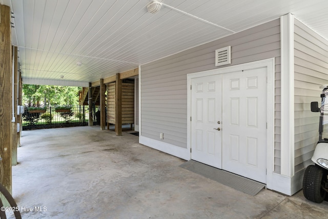 322 NE 42nd St, Oak Island, NC 28465 - view of exterior entry featuring a carport