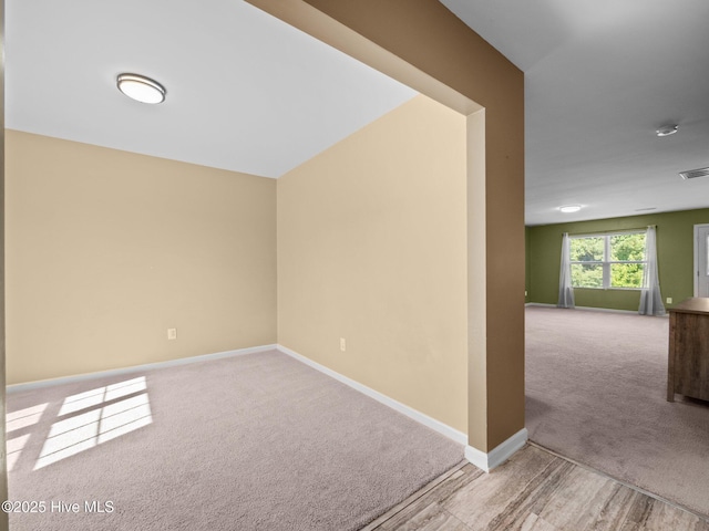 301 Stella Bridgeway Dr, Stella, NC 28582 - carpeted spare room with baseboards and a smoke detector