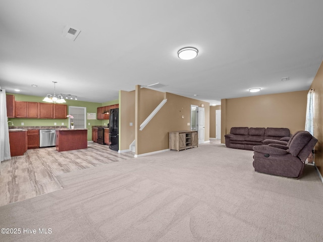301 Stella Bridgeway Dr, Stella, NC 28582 - unfurnished living room with a chandelier and light colored carpet
