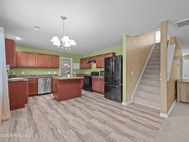 301 Stella Bridgeway Dr, Stella, NC 28582 - kitchen featuring black appliances, a kitchen island, a chandelier, under cabinet range hood, and hanging light fixtures