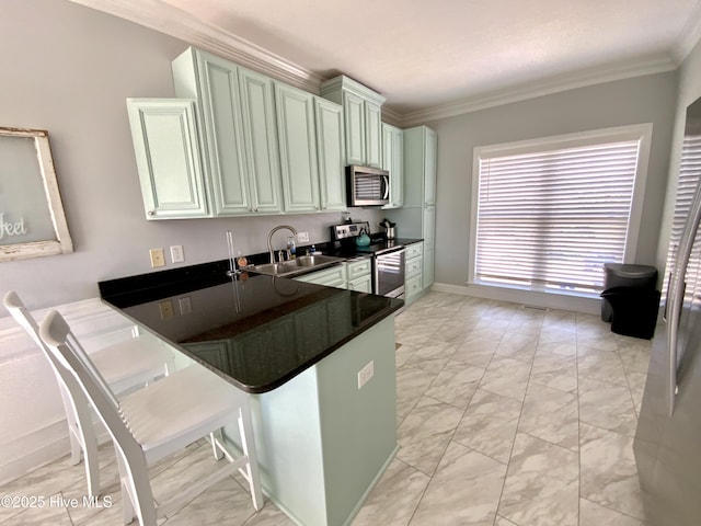 2911 E Pelican Dr, Oak Island, NC 28465 - kitchen with stainless steel appliances, light marble finish floors, a peninsula, crown molding, and dark countertops