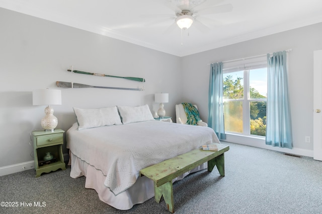 2911 E Pelican Dr, Oak Island, NC 28465 - carpeted bedroom with crown molding and ceiling fan