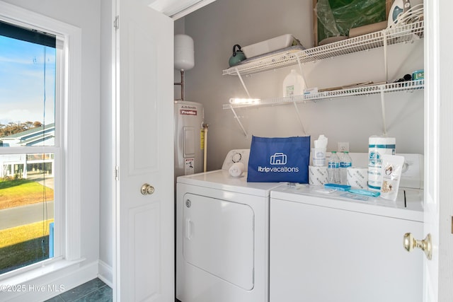 2911 E Pelican Dr, Oak Island, NC 28465 - laundry area featuring washing machine and clothes dryer, electric water heater, and tile patterned floors