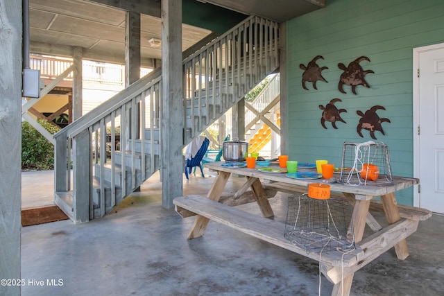 2911 E Pelican Dr, Oak Island, NC 28465 - view of patio / terrace with stairs and outdoor dining area