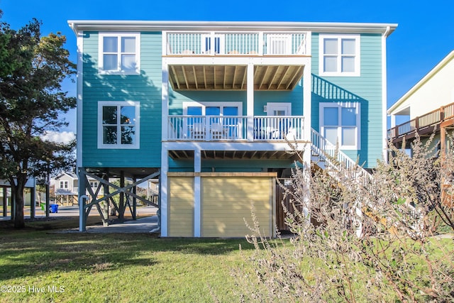 2911 E Pelican Dr, Oak Island, NC 28465 - back of property with stairway, a balcony, and a yard