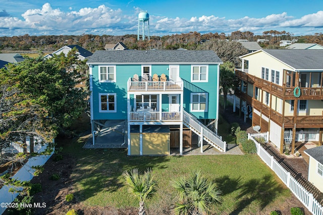 2911 E Pelican Dr, Oak Island, NC 28465 - back of property featuring a balcony, a fenced backyard, and stairway