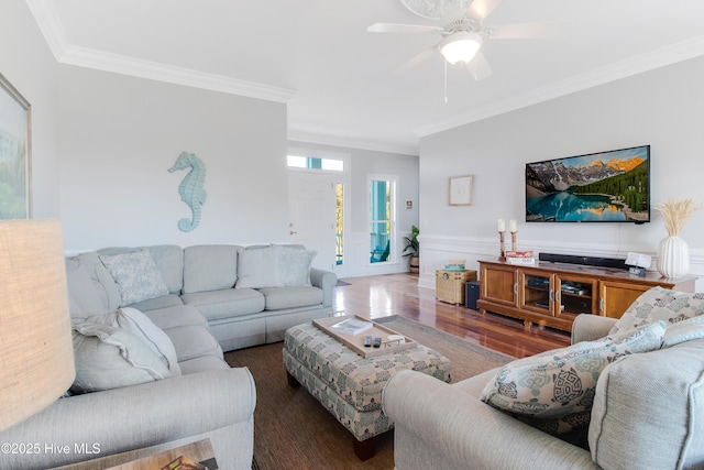 2911 E Pelican Dr, Oak Island, NC 28465 - living room with ornamental molding, wood finished floors, ceiling fan, and a wainscoted wall