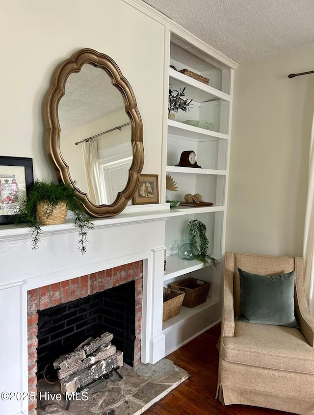 750 W 2nd St, Washington, NC 27889 - living area with a fireplace, a textured ceiling, and wood finished floors