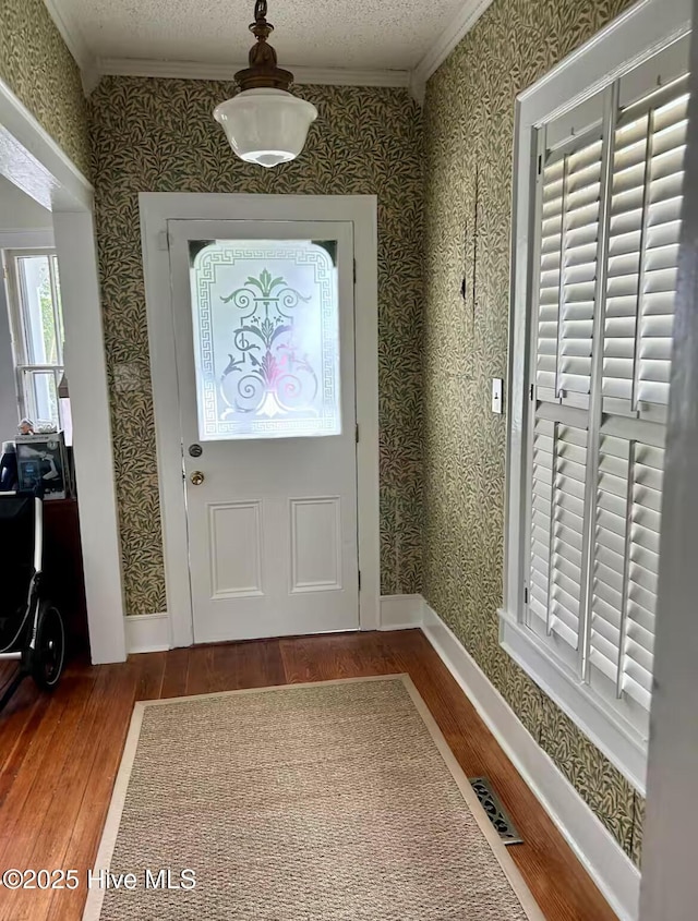 750 W 2nd St, Washington, NC 27889 - foyer with wood finished floors, wallpapered walls, and ornamental molding