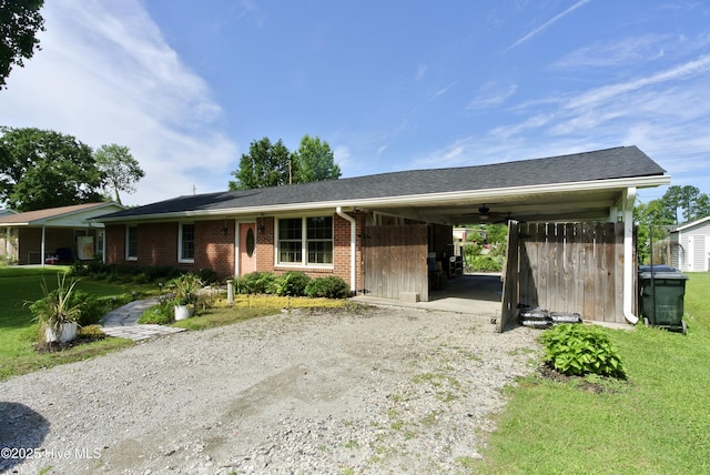 1307 Hunters Rd, New Bern, NC 28562 - ranch-style home with dirt driveway, an attached carport, brick siding, and a front yard