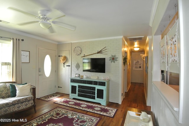 1307 Hunters Rd, New Bern, NC 28562 - living room featuring wood finished floors, crown molding, ceiling fan, and brick wall
