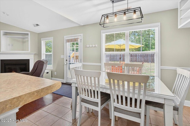 1009 Stonesthrow Ct, Leland, NC 28451 - tiled dining room featuring a glass covered fireplace and baseboards