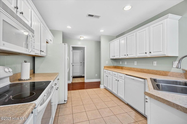 1009 Stonesthrow Ct, Leland, NC 28451 - kitchen with white appliances, white cabinetry, light tile patterned floors, light countertops, and recessed lighting