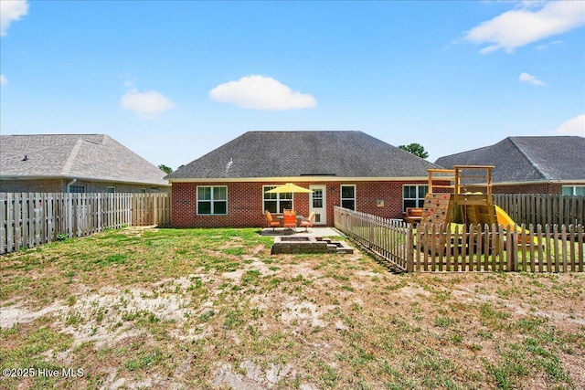 1009 Stonesthrow Ct, Leland, NC 28451 - back of property featuring a playground, a fenced backyard, and a patio area
