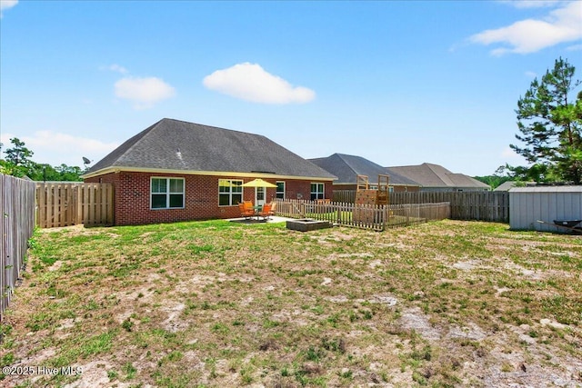 1009 Stonesthrow Ct, Leland, NC 28451 - back of property featuring a fenced backyard, a shed, brick siding, and a patio area