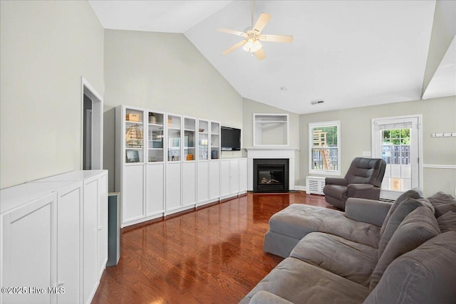 1009 Stonesthrow Ct, Leland, NC 28451 - living area featuring dark wood finished floors, a ceiling fan, high vaulted ceiling, and a fireplace with flush hearth