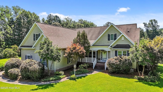 1910 Big Mill Rd, Williamston, NC 27892 - traditional-style house with a porch, a front yard, and a shingled roof