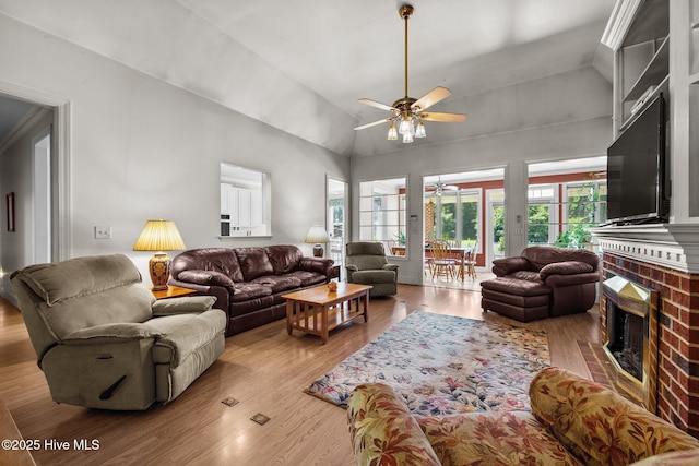 1910 Big Mill Rd, Williamston, NC 27892 - living room featuring a ceiling fan, a fireplace, vaulted ceiling, and wood finished floors