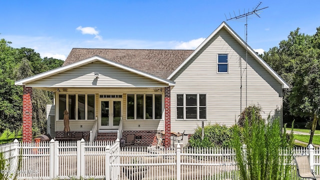 1910 Big Mill Rd, Williamston, NC 27892 - rear view of property featuring french doors, roof with shingles, and a fenced front yard
